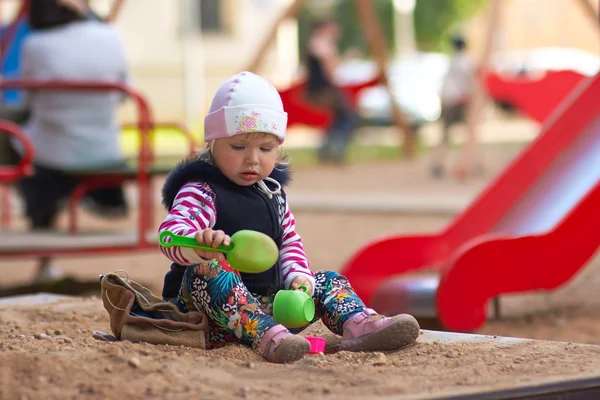 Little girl play with toys on sandbox — 스톡 사진