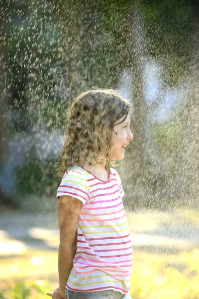 Girl enjoying the light summer rain. — Stock Photo, Image