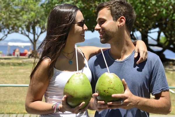 Happy couple drinking coconut water Royalty Free Stock Images