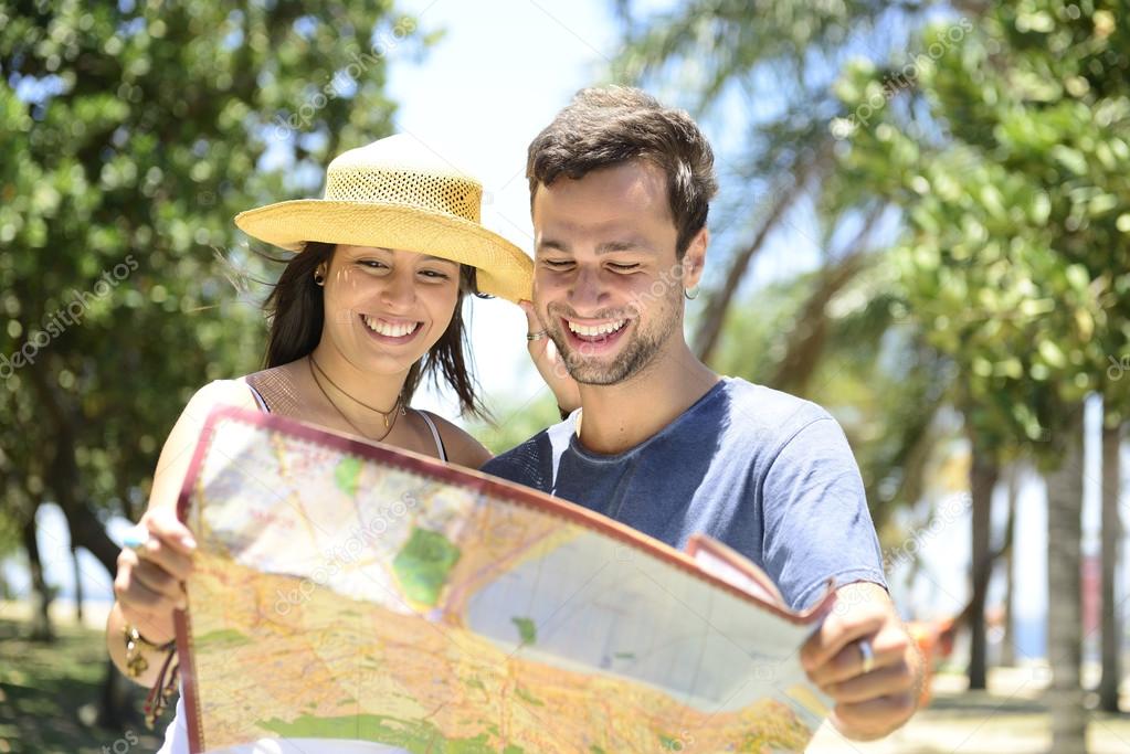 Happy tourist couple with map