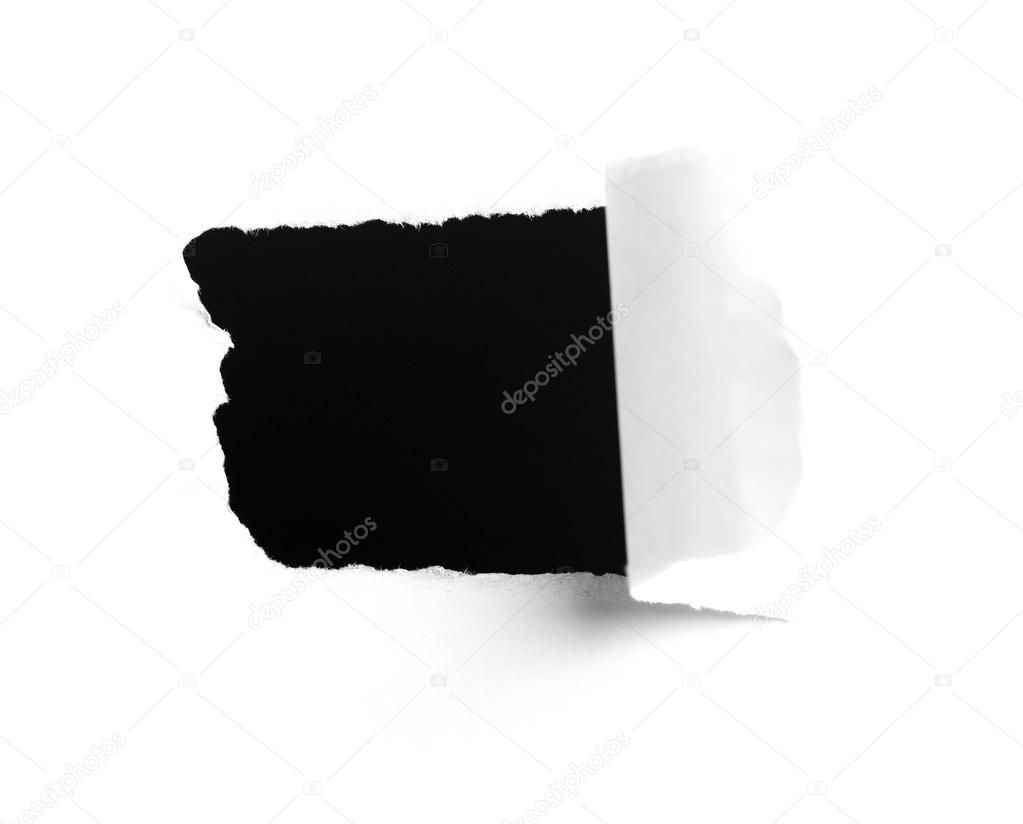 Closeup of a dark hole on white paper 