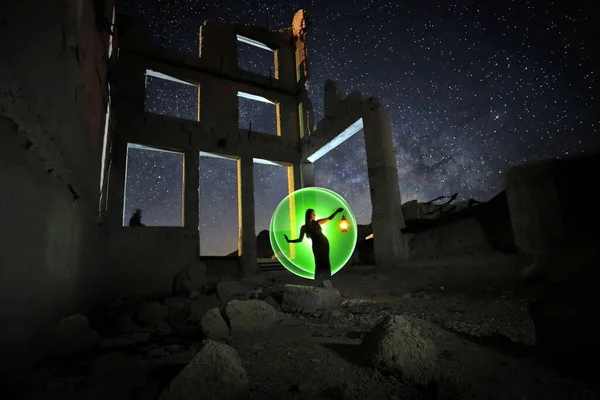 Fashionable Model Posing in the Desert at Night With Milky Way