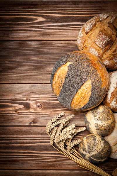 Bread assortment on wooden surface — Stock Photo, Image