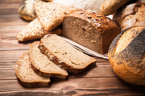 Bread assortment on wooden surface — Stock Photo, Image