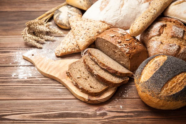 Bread assortment on wooden surface — Stock Photo, Image