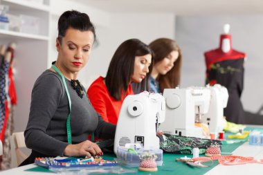 Women in a sewing workshop clipart
