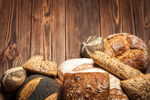Bread assortment on wooden surface — Stock Photo, Image