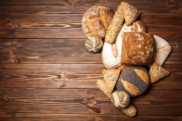 Bread assortment on wooden surface — Stock Photo, Image