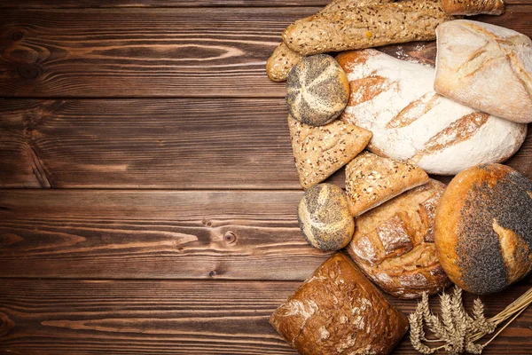 Bread assortment on wooden surface — Stock Photo, Image