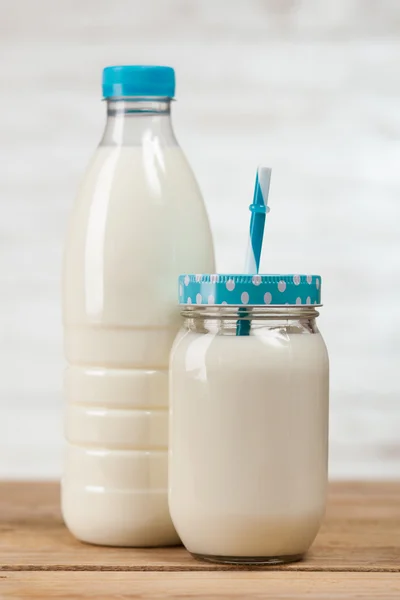 Botella de leche sobre mesa de madera — Foto de Stock