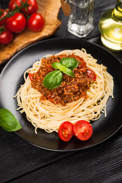 Spaghetti bolognese on dark background