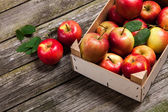 Fresh red apples in a wooden crate