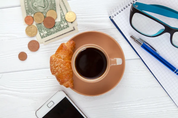 Coffee with croissant on a worktable — Stock Photo, Image