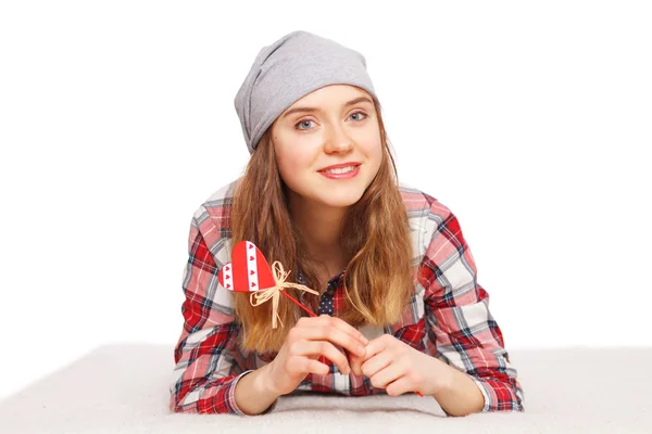 Portrait of a teenage girl with a heart symbol in her hands — Stock Photo, Image