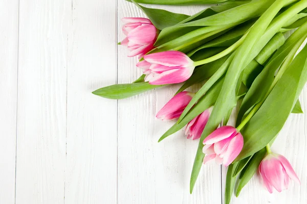 Beautiful tulips on white wood background — Stock Photo, Image