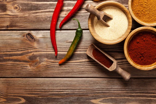 Bowls with spices on wood — Stock Photo, Image