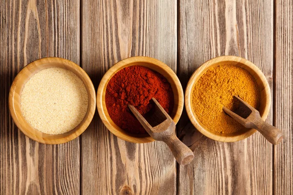 Bowls with spices on wood — Stock Photo, Image
