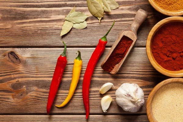 Bowls with spices on wood — Stock Photo, Image