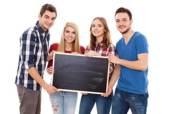 Groep van gelukkige jonge mensen met een schoolbord — Stockfoto