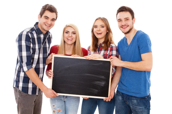 Skupina happy mladých lidí s tabulí — Stock fotografie