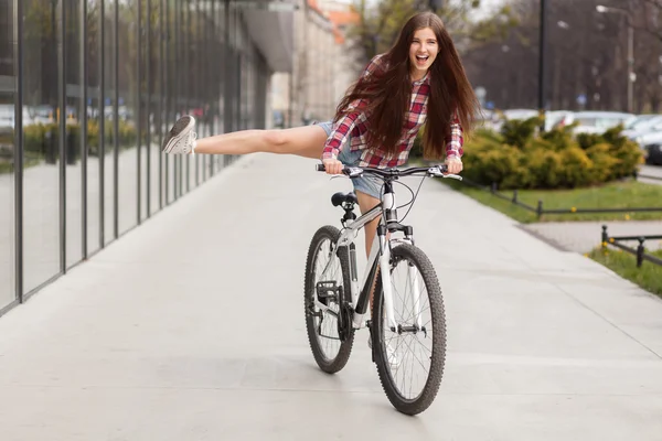Young beautiful woman on a bicycle — Stock Photo, Image