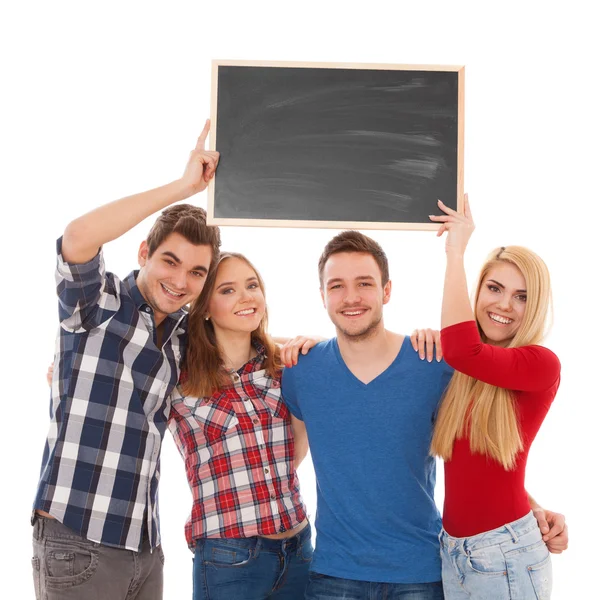 Groep van gelukkige jonge mensen met een schoolbord — Stockfoto