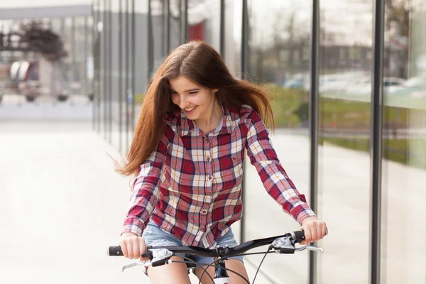 Young beautiful woman on a bicycle — Stock Photo, Image