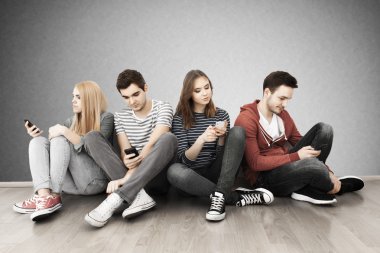 Akıllı telefonları olan bir grup genç.