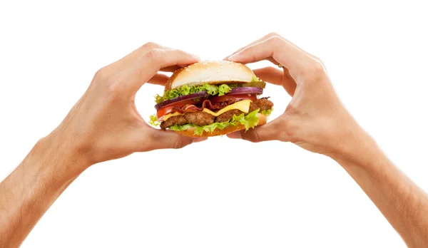 Hands holding a hamburger — Stock Photo, Image