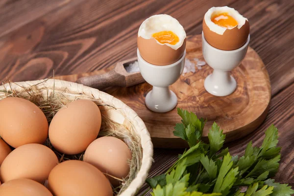 Boiled eggs on a wooden background — Stock Photo, Image