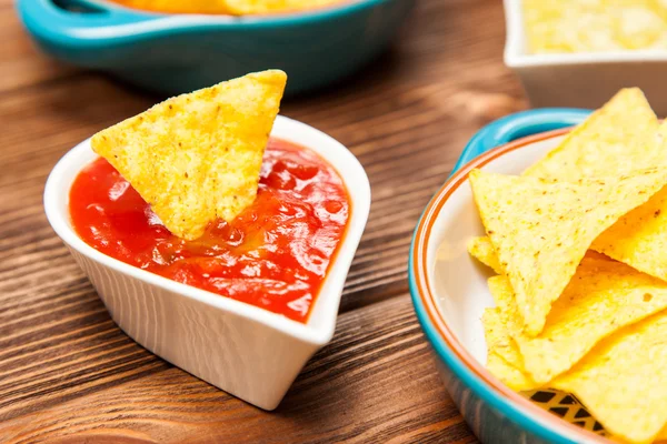 Plate of nachos with different dips