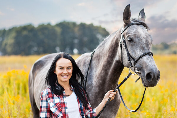 Young woman with a horse