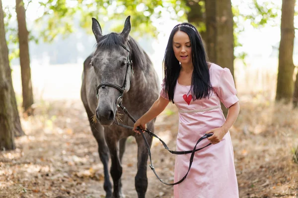 Jonge vrouw met een paard — Stockfoto