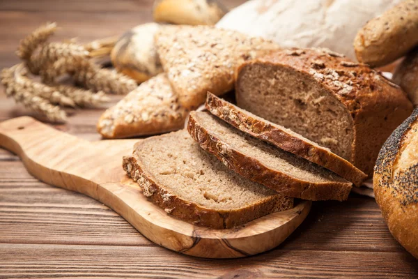 Bread assortment on wooden surface — Stock Photo, Image