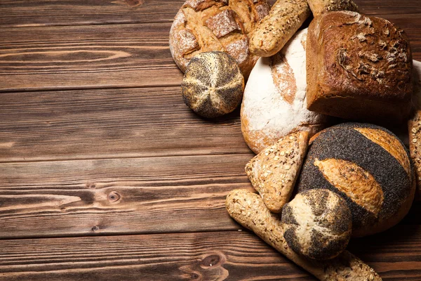 Bread assortment on wooden surface — Stock Photo, Image