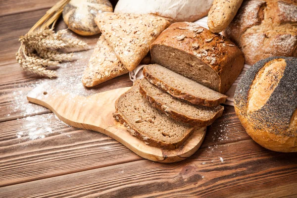 Bread assortment on wooden surface — Stock Photo, Image