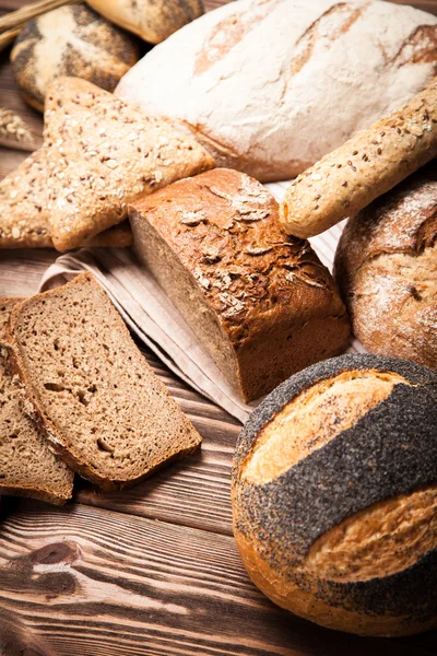 Bread assortment on wooden surface — Stock Photo, Image