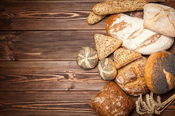 Bread assortment on wooden surface — Stock Photo, Image