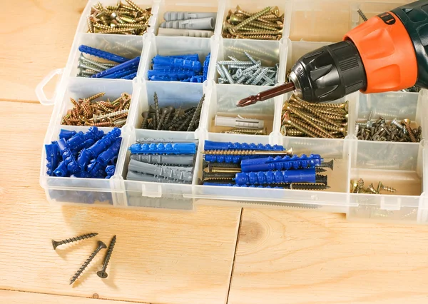 Cordless drill, screws and toolbox — Stock Photo, Image