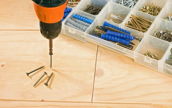 Cordless drill, screws and toolbox — Stock Photo, Image