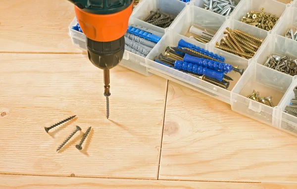 Cordless drill, screws and toolbox — Stock Photo, Image