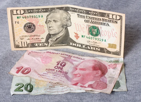 Financial crisis: new ten dollars over thirty crumpled turkish liras — Stock Photo, Image