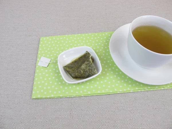 Cup of herbal tea with matcha tea bag — Stock Photo, Image