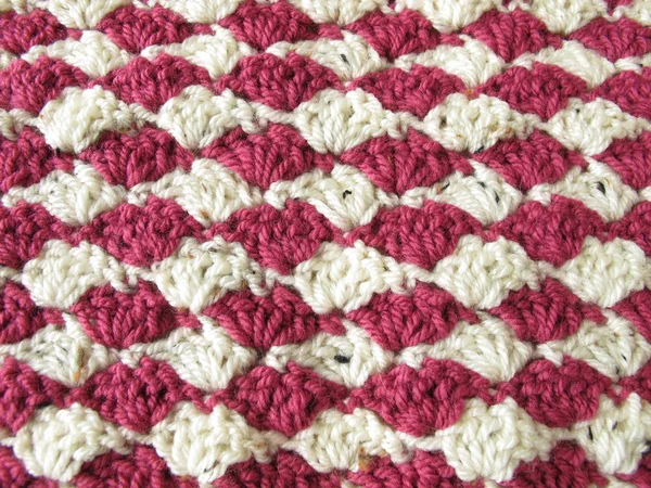 Background of two-toned crocheted shells in berry colors Stock Picture