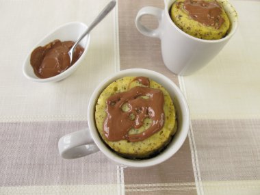 Mug Cake from microwave with poppy-seeds and chocolate icing clipart