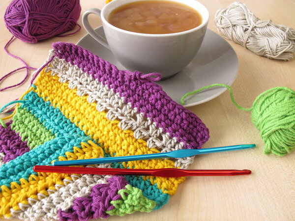Crochet work and a cup of coffee with milk