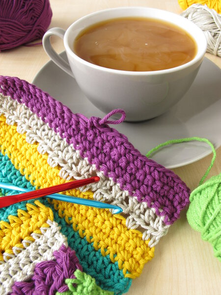 Crochet work and a cup of coffee with milk