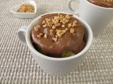 Mug Cake with chocolate icing and almond brittle clipart