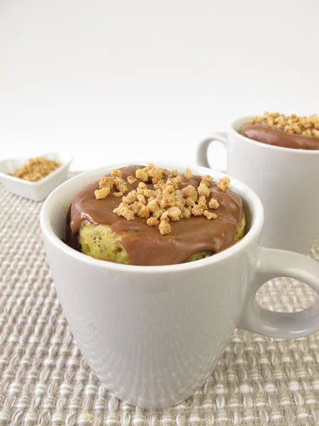 Mug Cake with chocolate icing and almond brittle — Stock Photo, Image