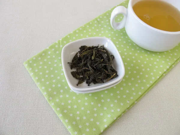 Loose ceylon royal silver white tea and cup of tea — Stock Photo, Image